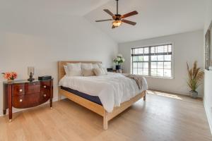 a bedroom with a bed and a ceiling fan at Prime Peoria Retreat with Deck and Fireplace! in Peoria