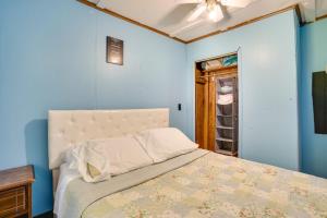 a bedroom with a bed with blue walls and a ceiling at French Lick Getaway with Deck, Grill and Fire Pit! in French Lick