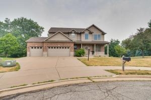 a house with a driveway in front of it at Prime Peoria Retreat with Deck and Fireplace! in Peoria