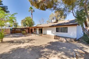 a house with a palm tree in front of it at Quiet Ridgecrest Vacation Rental with Private Yard! in Ridgecrest