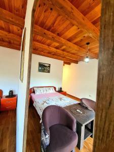 a bedroom with a bed and a table and chairs at S&M Apartments in Rijeka Crnojevića