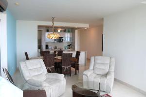 a living room with two chairs and a table at 07D Great Value Luxury Resort Beachfront Oceanview in ArraijÃ¡n