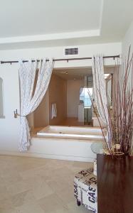 a room with a large window with a bath tub at Playa Bonita Rosarito in Rosarito