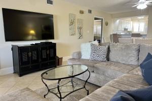 a living room with a couch and a glass table at Newly Listed! 20 Percent Off! Golf and Tennis Community Retreat in Wesley Chapel