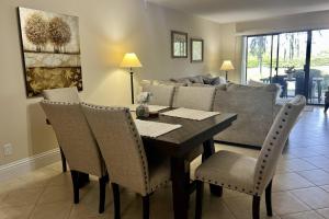 a dining room with a table and chairs and a couch at Newly Listed! 20 Percent Off! Golf and Tennis Community Retreat in Wesley Chapel