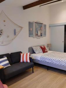 a living room with a bed and a couch at Maria do Mar_As Três Marias in Matosinhos