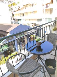 a blue table and chairs on a balcony at CKBSM Central Square Apartment Kalamata in Kalamata