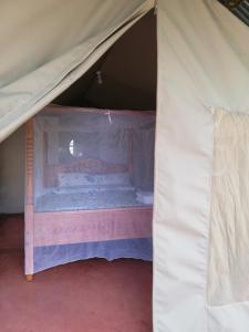 a room with a bed in a tent at Mara Forest camp in Keekorok