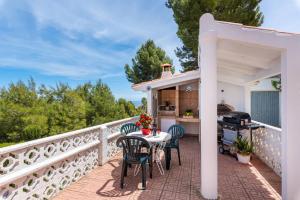 a patio with a table and chairs on a balcony at Villa Rosario - PlusHolidays in Calpe