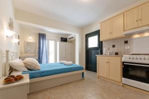 a bedroom with a bed in a kitchen at Studios Farma in Agia Anna Naxos