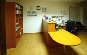 an office with a wooden desk and a book shelf at Bacan Serviced Apartments in Cavtat