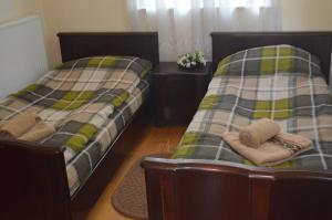 Ein Bett oder Betten in einem Zimmer der Unterkunft Alex's Cosy Guesthouse