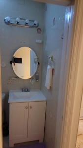 a bathroom with a mirror and a sink at Sunrise Efficiency in Sunrise