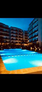 een groot zwembad voor een groot gebouw bij Luxurious Mannesmann Beach in Mohammedia
