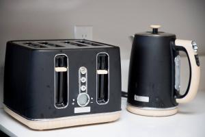 a black toaster and a coffee pot on a counter at Beautiful View Point Villa in Conifer