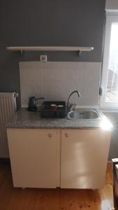 a kitchen with a sink and a counter top at Casablanca in Niš