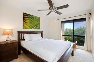 um quarto com uma cama, uma ventoinha de tecto e uma janela em K B M Resorts Kaanapali KPL-41 3 bdm wRental Car em Kaanapali