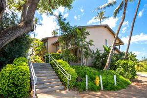 a house with stairs and palm trees in front of it at K B M Resorts Kaanapali KPL-41 3 bdm wRental Car in Kaanapali