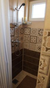 a bathroom with a shower with a window at Casablanca in Niš
