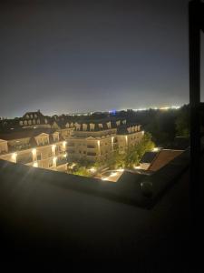 a view of a city at night with buildings at PENTHOUSE Terrasse Jacuzzi 6 voyageurs in Le Blanc-Mesnil