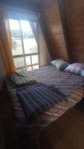 a bedroom with two beds in a room with a window at Don Cleto in Aiguá