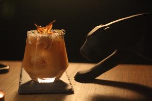 a drink sitting on top of a wooden table at Hotel Casa HX - Adults Only in Holbox Island