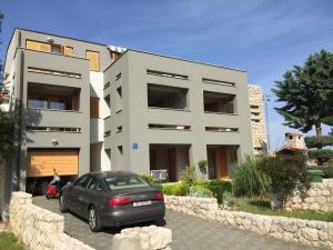 a car parked in front of a building at Apartments Smiljanic in Tribunj