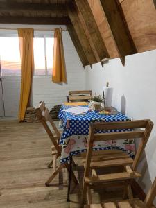 a dining room with a table and two chairs at Don Cleto "La Mimosa" in Aiguá