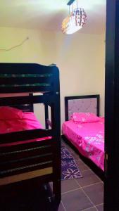 a bedroom with two bunk beds and a chandelier at جولف بيه برتو السخنه in As Suways
