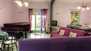 a living room with a purple couch and a table at The Secret Garden Maratea - Casa di Elena in Maratea