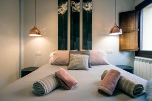 a bedroom with a large bed with two pillows on it at El Arco San Esteban by Unique Rooms in Burgos