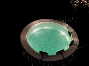 a pool of water at night in a lightedescription at Bungalow avec vue dans lieu calme in Le Carbet