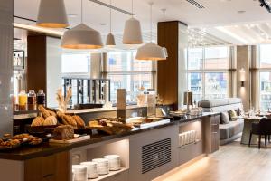 a bakery with bread and pastries on a counter at AC Hotel by Marriott Belfast in Belfast