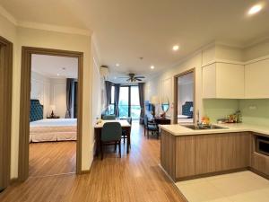 a kitchen and a bedroom with a bed and a table at Blue Rose - Sea View, High Floor, 70m2 apartment, 2 Bedrooms, 2 WC, in Ha Long