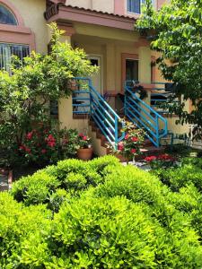 a house with blue railings and flowers in front of it at Levander Cozy Home in Alhambra