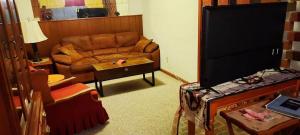 a living room with a couch and a television at Sandie's Country Bed and Bath in Chiefland