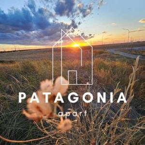 a sunset in a field with the words patagonia support at Alojamiento Patagonia centro in Viedma