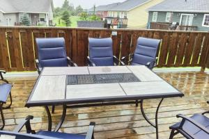 a patio table and chairs on a deck at Coco home in Charlottetown