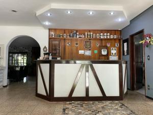 a lobby with a large counter in a room at Hotel Blumenhof in Blumenau