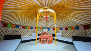 a room with a tent with a table in it at miniモンゴルキャンプ場 in Gujo