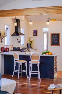 a kitchen with two chairs and a blue counter top at The Rustic Cottage - Canungra in Canungra