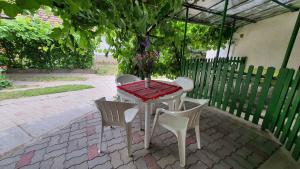 a table with two chairs and a table with a tree at Holiday home in Siofok - Balaton 43122 in Siófok