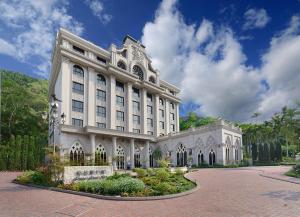 un gran edificio blanco con un jardín delante de él en 格拉斯行館 Grasse Grace Manor, en Nanzhuang