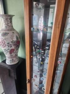a glass display case with a vase in it at Beautiful home near mall & beach in St. Petersburg