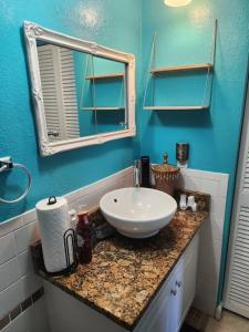 a bathroom with a white sink and a mirror at Beautiful home near mall & beach in St. Petersburg