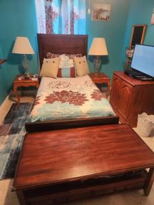 a bedroom with a bed and two tables with lamps at Beautiful home near mall & beach in St. Petersburg