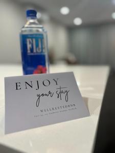 a bottle of water and a sign that says enjoy your stay at Modern Griffith Apartment in Kingston 
