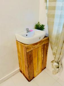 a bathroom with a sink and a shower curtain at Babu Backpackers inn in Moalboal