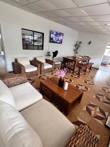 a living room with white couches and a table at Casa de campo San Juan del Puente en Villeta in Villeta