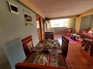 a living room with a table and a couch at Casa Mirador SanBlas in Cusco